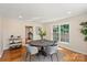 Bright dining room features hardwood floors, modern lighting and a round table for intimate dinners at 6034 Tuckaseegee Rd, Charlotte, NC 28208