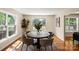 Dining room with natural light, round table with seating for six, and hardwood floors at 6034 Tuckaseegee Rd, Charlotte, NC 28208