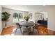 Bright dining area with natural light, round table, hardwood floors, and access to living space at 6034 Tuckaseegee Rd, Charlotte, NC 28208