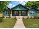 Beautifully renovated craftsman home with inviting front porch and manicured lawn at 6034 Tuckaseegee Rd, Charlotte, NC 28208