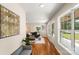 Elegant hallway leading to a bright living area with hardwood floors and decorative art at 6034 Tuckaseegee Rd, Charlotte, NC 28208
