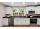 Updated kitchen featuring stainless appliances, white cabinets, and granite countertops at 6034 Tuckaseegee Rd, Charlotte, NC 28208