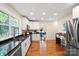 Modern kitchen with stainless steel appliances, granite countertops, and hardwood flooring throughout at 6034 Tuckaseegee Rd, Charlotte, NC 28208