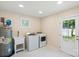 Laundry Room with a new washer and dryer, utility sink, and access to backyard at 6034 Tuckaseegee Rd, Charlotte, NC 28208