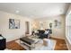 Cozy living room with hardwood floors, neutral colors, and comfortable seating arrangements at 6034 Tuckaseegee Rd, Charlotte, NC 28208
