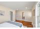 Spacious main bedroom with hardwood floors and access to the en-suite bathroom at 6034 Tuckaseegee Rd, Charlotte, NC 28208