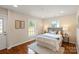 Cozy main bedroom with natural light, hardwood floors, and neutral decor at 6034 Tuckaseegee Rd, Charlotte, NC 28208