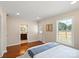 Well-lit main bedroom featuring hardwood floors and a window view to the outdoors at 6034 Tuckaseegee Rd, Charlotte, NC 28208