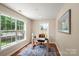 Bright home office with large windows, hardwood floors, and a modern desk setup at 6034 Tuckaseegee Rd, Charlotte, NC 28208