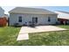 Back of house featuring patio with table and chairs, well-maintained lawn, and wood privacy fence at 6719 Jerimoth Dr, Charlotte, NC 28215