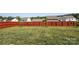 Large grassy backyard with a new stained fence creating a quiet space at 6719 Jerimoth Dr, Charlotte, NC 28215