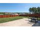 Wide backyard with healthy grass, bordered by a wood privacy fence and patio with seating at 6719 Jerimoth Dr, Charlotte, NC 28215