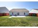Back of house featuring a patio, well-maintained lawn, and wood privacy fence at 6719 Jerimoth Dr, Charlotte, NC 28215