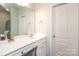 Bright bathroom featuring a large mirror, ample counter space, and a pristine white vanity at 6719 Jerimoth Dr, Charlotte, NC 28215
