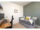 Home office in the bedroom features an adaptable sofa for guests and decor with neutral wall paint at 6719 Jerimoth Dr, Charlotte, NC 28215
