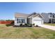 Charming single-Gathering home featuring a manicured lawn, a two-car garage, and attractive landscaping at 6719 Jerimoth Dr, Charlotte, NC 28215