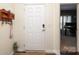 Bright foyer with a white front door, adjacent study, and key rack, offering a welcoming entrance at 6719 Jerimoth Dr, Charlotte, NC 28215