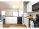 Spacious kitchen with stone countertops, black appliances, and an open view of the living area at 6719 Jerimoth Dr, Charlotte, NC 28215