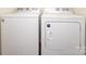 Matching washer and dryer set sit side-by-side in a modern laundry room at 6719 Jerimoth Dr, Charlotte, NC 28215