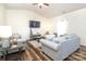 Bright living room featuring cozy gray sofas, wood floors, and plenty of natural light for a welcoming atmosphere at 6719 Jerimoth Dr, Charlotte, NC 28215