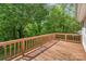 Wooden back deck overlooks a backyard full of mature trees at 7106 Marlbrook Dr, Charlotte, NC 28212