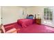 Cozy bedroom featuring red carpet, a quaint bed, and traditional furniture accents at 7106 Marlbrook Dr, Charlotte, NC 28212