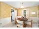 Cozy dining room featuring stylish wallpaper, natural light, and seating for four at 7106 Marlbrook Dr, Charlotte, NC 28212