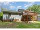 Back exterior of home with wooden porch overlooking lawn at 7106 Marlbrook Dr, Charlotte, NC 28212