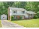 View of the home's side yard and driveway, with mature landscaping and a storage shed at 7106 Marlbrook Dr, Charlotte, NC 28212