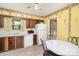 Traditional kitchen with wood cabinets, laminate countertops, appliances, and a dining area at 7106 Marlbrook Dr, Charlotte, NC 28212