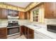 Classic kitchen with wooden cabinets, stainless steel appliances, and a sink overlooking a window at 7106 Marlbrook Dr, Charlotte, NC 28212