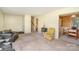 Bright living room with neutral carpet, multiple seating options, and access to dining area at 7106 Marlbrook Dr, Charlotte, NC 28212