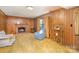Inviting living room with paneled walls, brick fireplace, and warm, textured carpeting at 7106 Marlbrook Dr, Charlotte, NC 28212