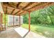 Covered patio with concrete floor overlooks fenced in backyard and storage shed at 7106 Marlbrook Dr, Charlotte, NC 28212