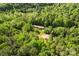 Aerial shot of a mobile home in the forest with a small pond nearby at 743 Dream Ln, Salisbury, NC 28146