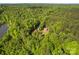 Aerial view of a property surrounded by lush greenery and a body of water at 743 Dream Ln, Salisbury, NC 28146