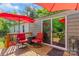 Inviting outdoor deck with cozy seating and umbrella, ideal for enjoying peaceful moments outside the sliding glass door at 743 Dream Ln, Salisbury, NC 28146