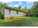 This home's backyard shows the deck with red umbrellas on a grassy lawn, perfect for outdoor living and entertaining at 743 Dream Ln, Salisbury, NC 28146