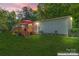 Charming home featuring a lovely wooden deck perfect for outdoor relaxation and entertaining under bright red umbrellas at 743 Dream Ln, Salisbury, NC 28146