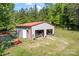 Two-car garage and workshop area for projects and storage, with lawn equipment and an additional doorway at 743 Dream Ln, Salisbury, NC 28146