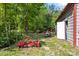 Equipment in the wooded yard, with lawn and forest and storage by the open side door at 743 Dream Ln, Salisbury, NC 28146