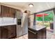 Well-lit kitchen boasts stainless steel refrigerator, island, and easy access to outdoor living space at 743 Dream Ln, Salisbury, NC 28146