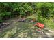 Wooded lot filled with various implements and machines under a canopy of mature trees at 743 Dream Ln, Salisbury, NC 28146