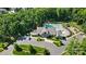 Community aerial view with clubhouse, pool, playground, parking, and lush landscaping, offering a resort-style living experience at 1005 Grand Oak Dr, Waxhaw, NC 28173