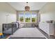 Inviting Bedroom with large windows, crib, neutral tones, and ample natural light at 1005 Grand Oak Dr, Waxhaw, NC 28173