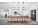 Open-concept kitchen with a large island, white cabinets, and modern pendant lighting at 1005 Grand Oak Dr, Waxhaw, NC 28173