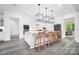 Bright, modern kitchen featuring a large center island, pendant lighting, and stainless appliances at 1005 Grand Oak Dr, Waxhaw, NC 28173