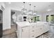Spacious kitchen island with white countertops, modern faucet, and views of the living area at 1005 Grand Oak Dr, Waxhaw, NC 28173