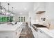 Modern kitchen featuring a large island with white countertops and view to the cooktop with custom range hood at 1005 Grand Oak Dr, Waxhaw, NC 28173