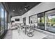 Elegant sunroom features a black ceiling, white brick wall, and seamless indoor-outdoor living with views of the backyard at 1005 Grand Oak Dr, Waxhaw, NC 28173